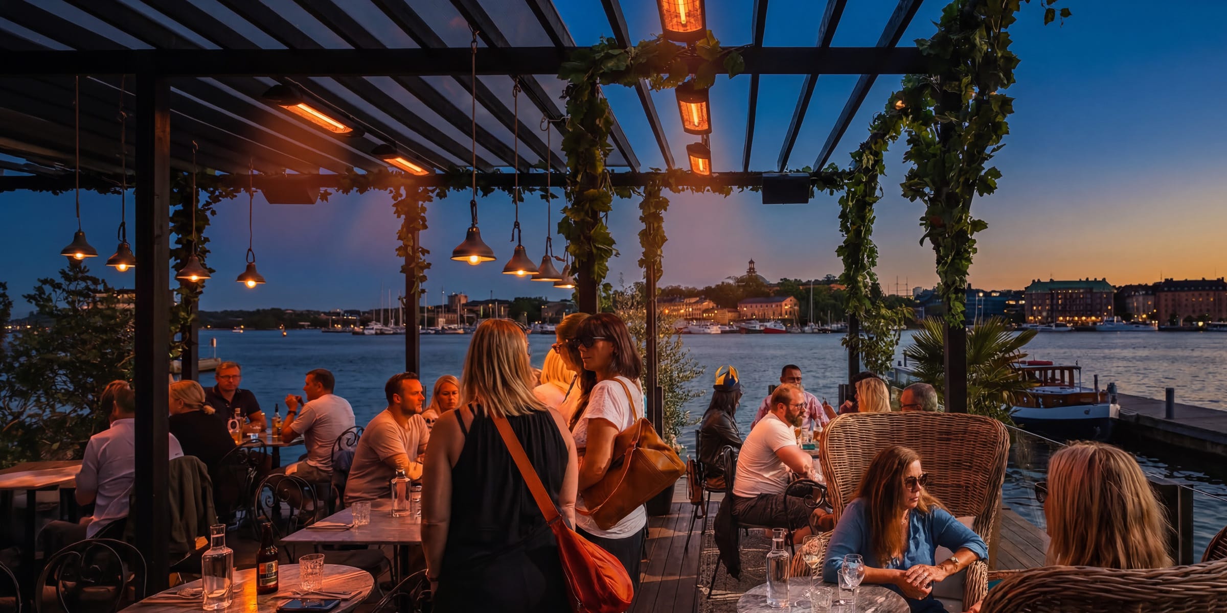 Restaurant terrace with overhead infrared heaters at dusk